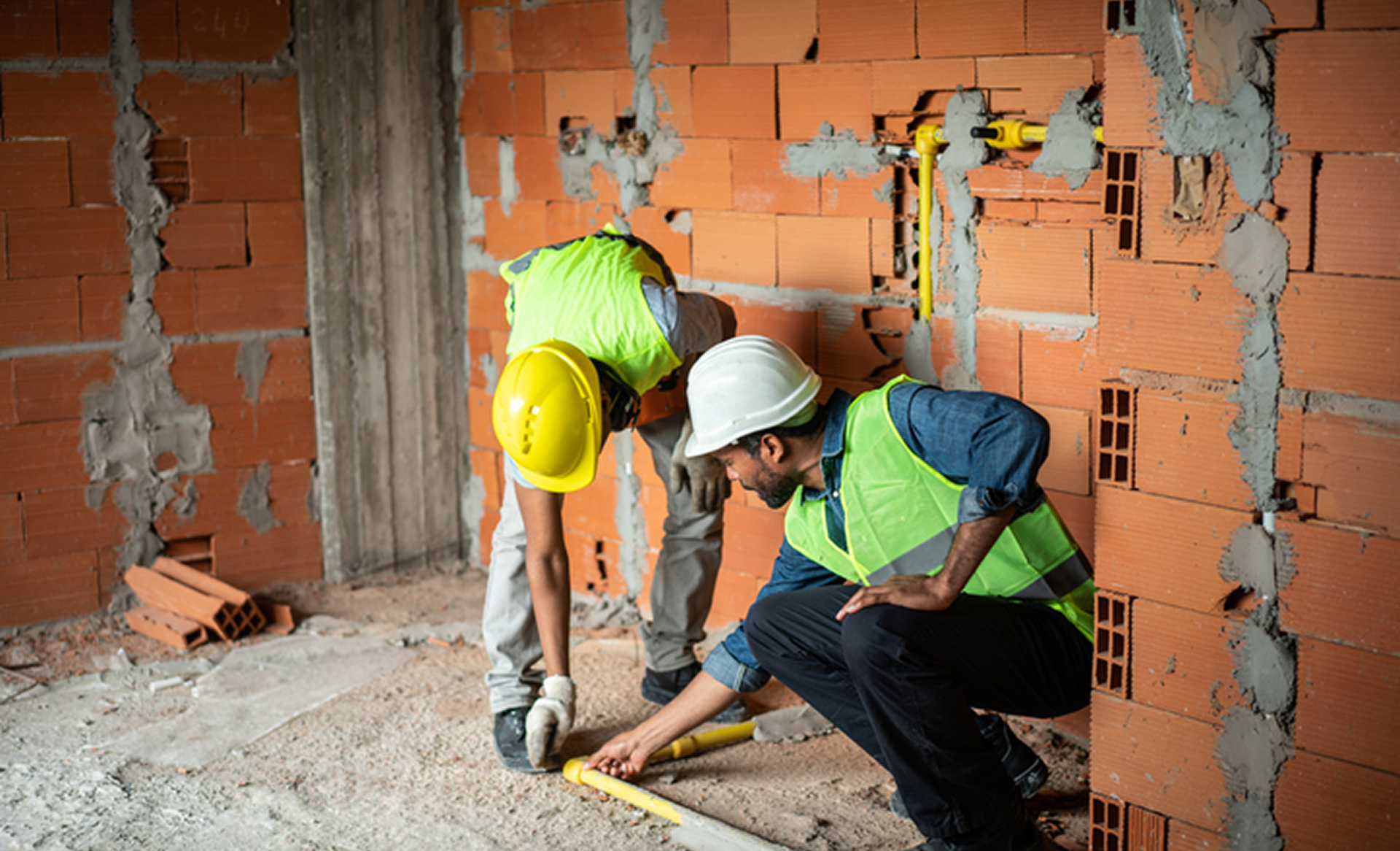 Inspecting wall measurements on construction site