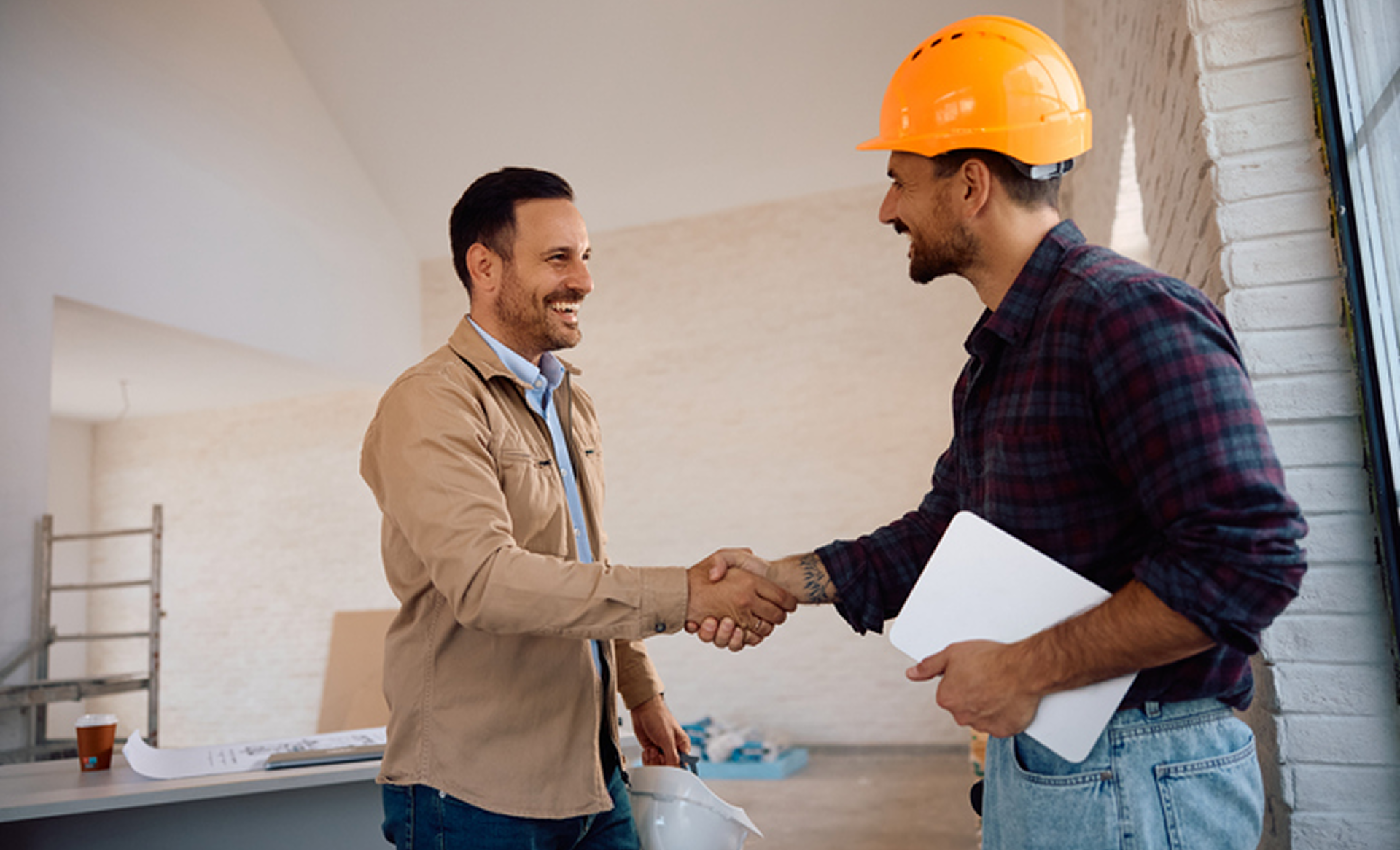 Construction workers shaking hands in agreement.